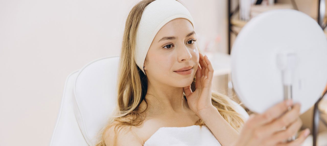 woman-looking-in-mirror-after-treatment